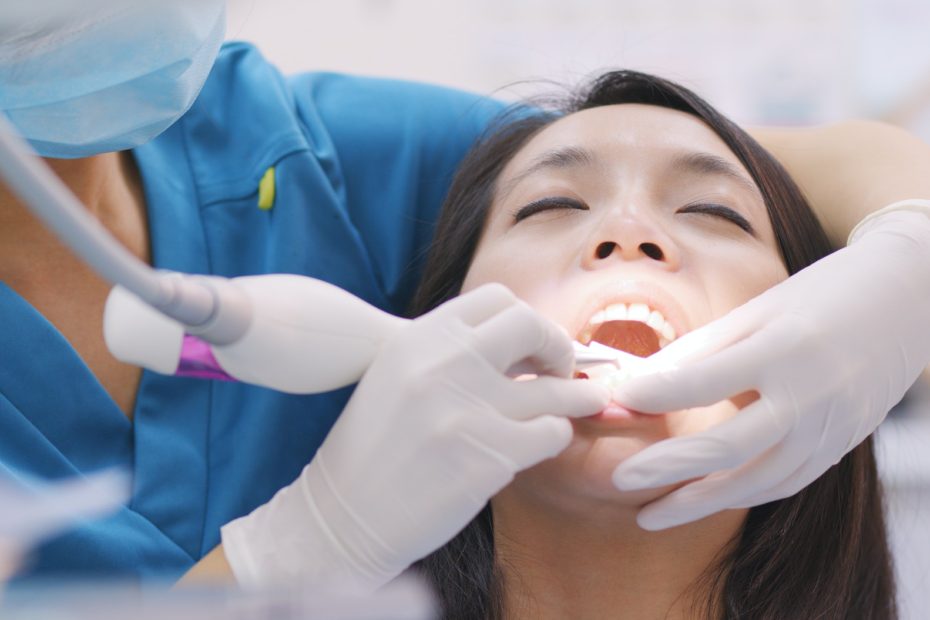 Woman doing Scaling and root planing in dental clinic